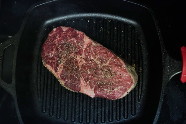 A ribeye on a cast-iron grill is an excellent alternative to outdoor grilling because the cast-iron will evenly retain heat well.