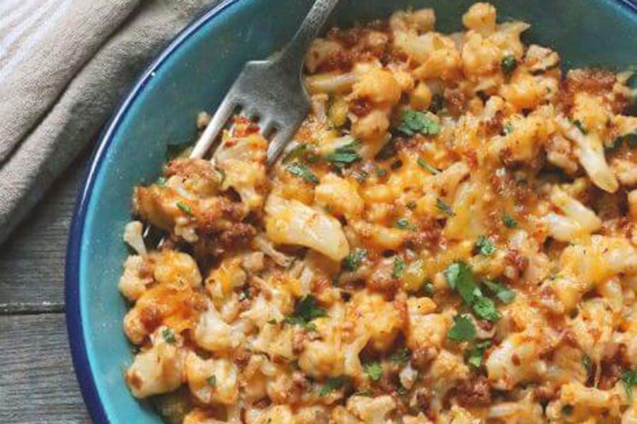 Enjoy a Helping of Pork Chorizo and Green Chili Cauliflower Mac N’ Cheese 1 Light blue platter of noodles and Mexican brand chorizo on a wooden table.