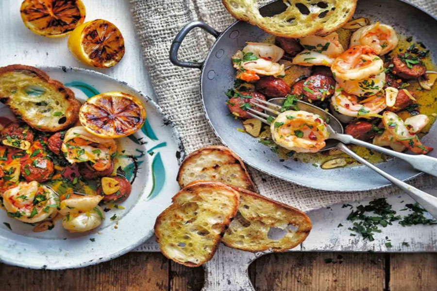 Try This Mouthwatering Shrimp with Chorizo! 1 white plate featuring large grilled shrimp and the best chorizo brand De San Manuel.