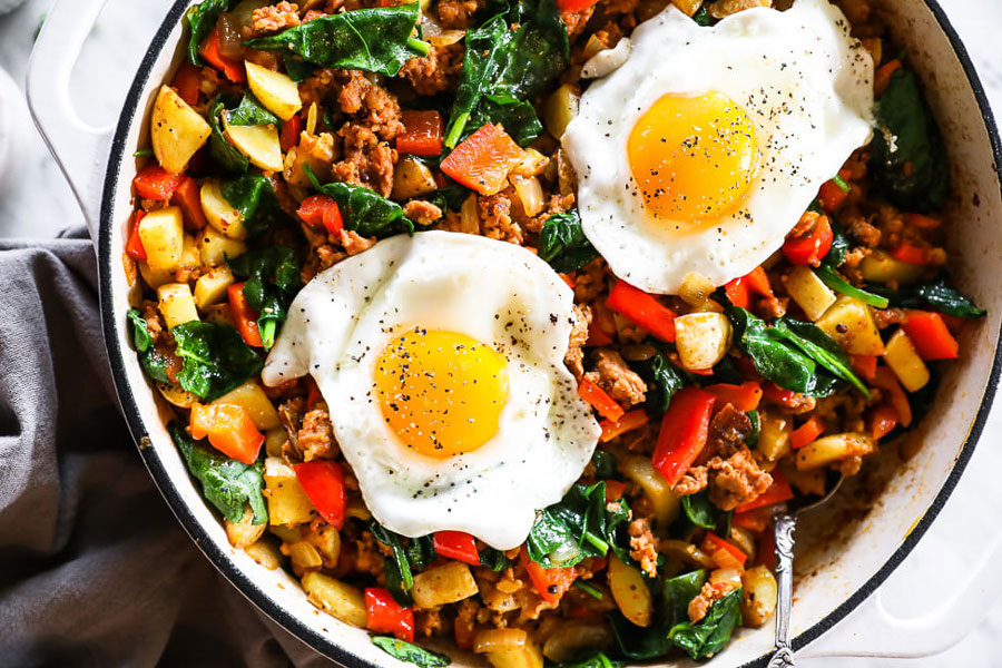 Fried eggs plopped inside a stew of hash potatoes and mexican chorizo