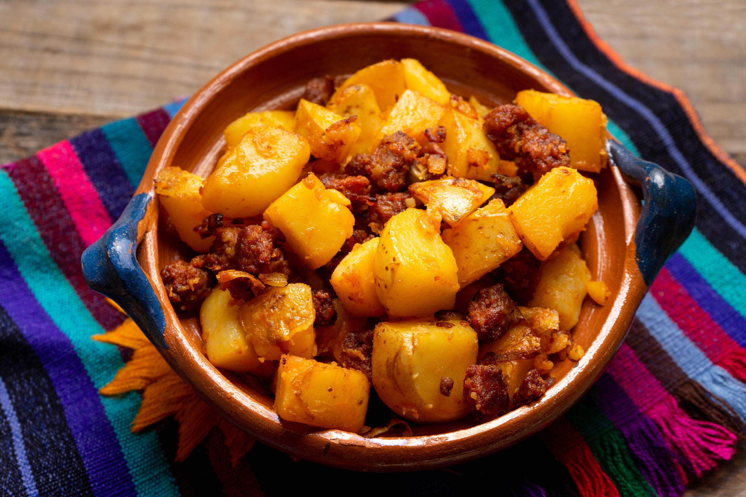 Traditional mexican potatoes with Texas brand chorizo on wooden background
