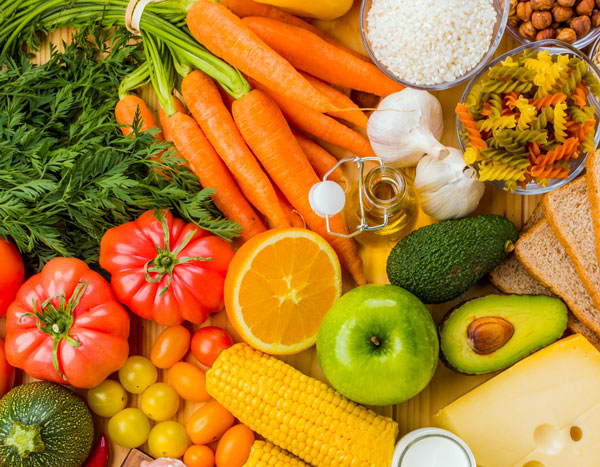 different colored vegetables on top of wooden plate