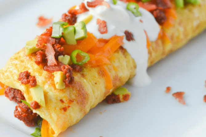 Get Egg-cited for Keto Chorizo Omelettes! 1 Large Yellow egg omelette topped with Mexican chorizo and pork chorizo from Chorizo De San Manuel