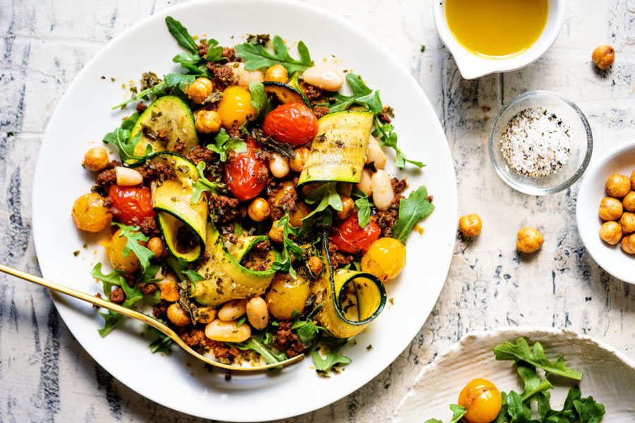 white platter of warm bean salad and mexican chorizo from Chorizo de San Manuel