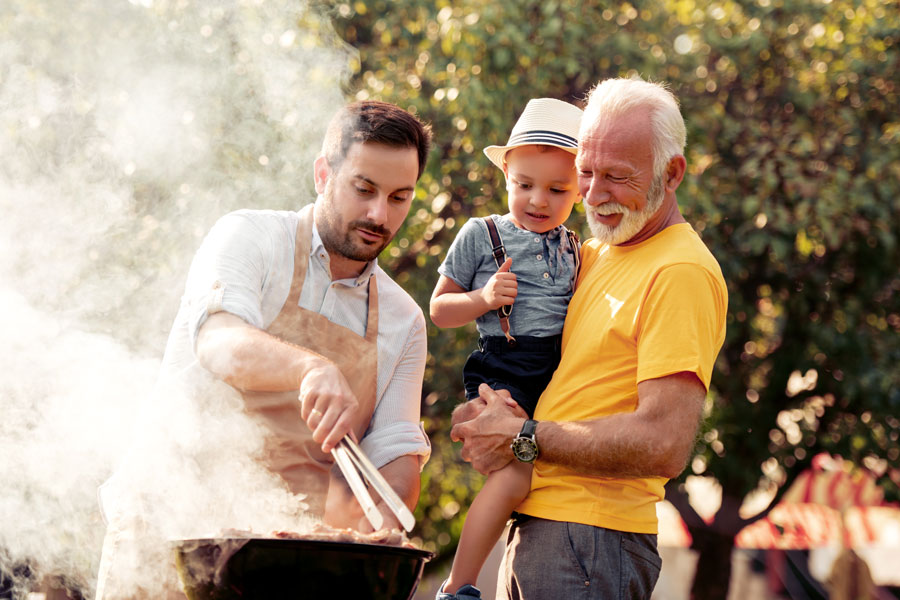 3 Generations of Men Cooking our Prime Beef products marinated beef fajitas sizzling on black skillet