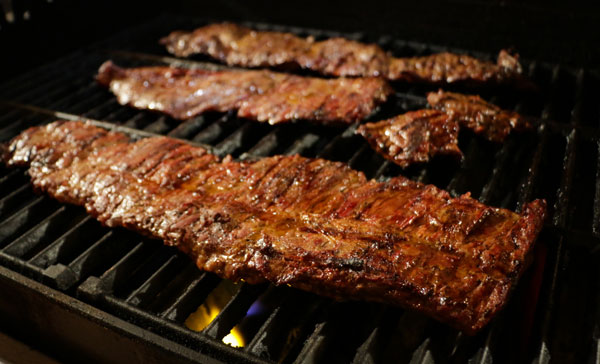 Prime Beef products resting on a wooden chopping block.