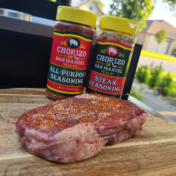 Two local seasoning bottles next to a prime steak.