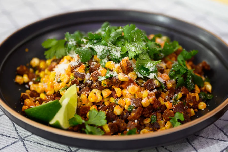 Large bowl of texas brand chorizo on white table.