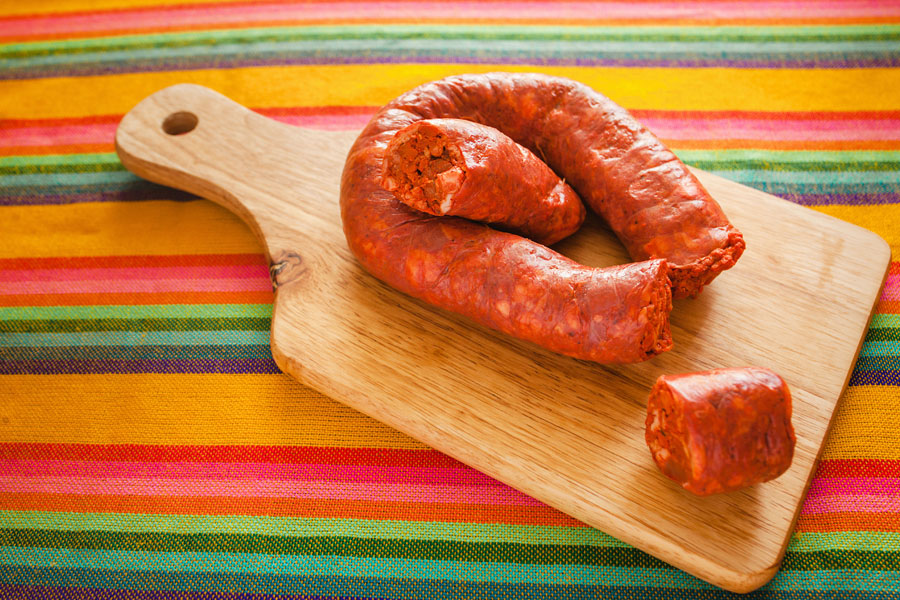 Chorizo De San Manuel Mexican chorizo plated on a wooden platter.