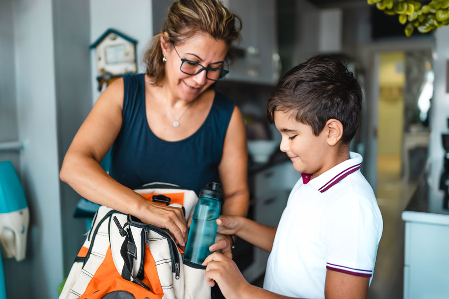 grandma handing boy lunch with mexican chorizo.