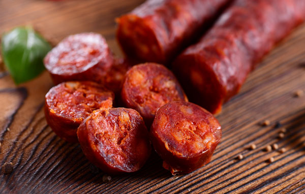 Mexican chorizo fresh on a wooden skillet from Chorizo De San Manuel.