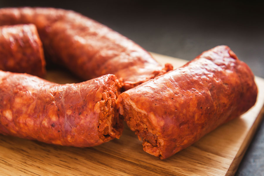 Tasty Mexican chorizo fresh on a wooden skillet from Chorizo De San Manuel.