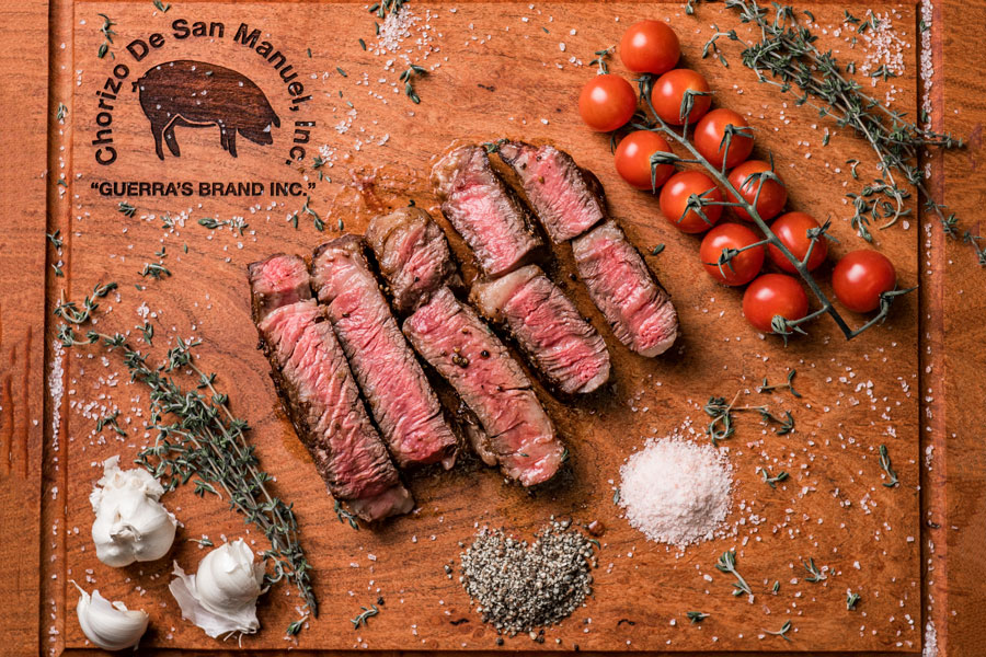 platter of prime beef products on a wooden chopping board.