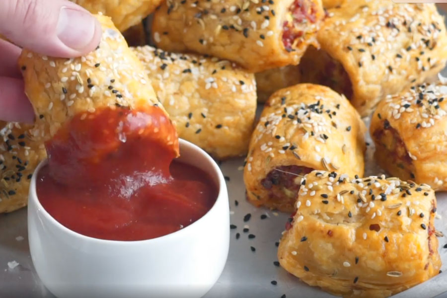 Gray platter with mexican chorizo rolls on kitchen counter.