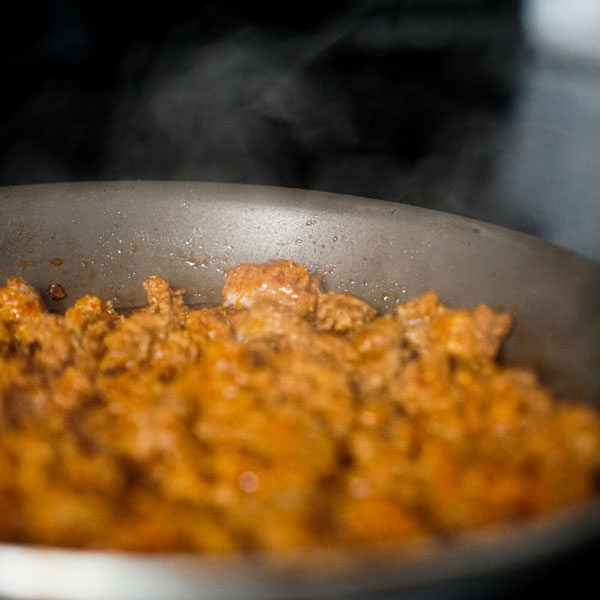 chorizo frying on a pan