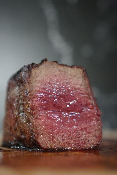 Prepping prime steak for the grill.