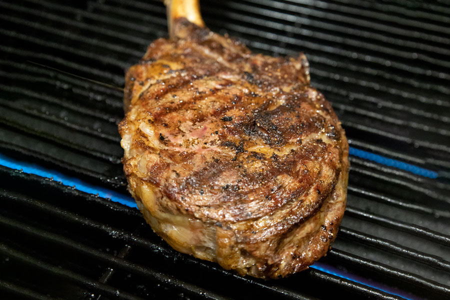 prime steaks on barbecue pit at Chorizo De San Manuel