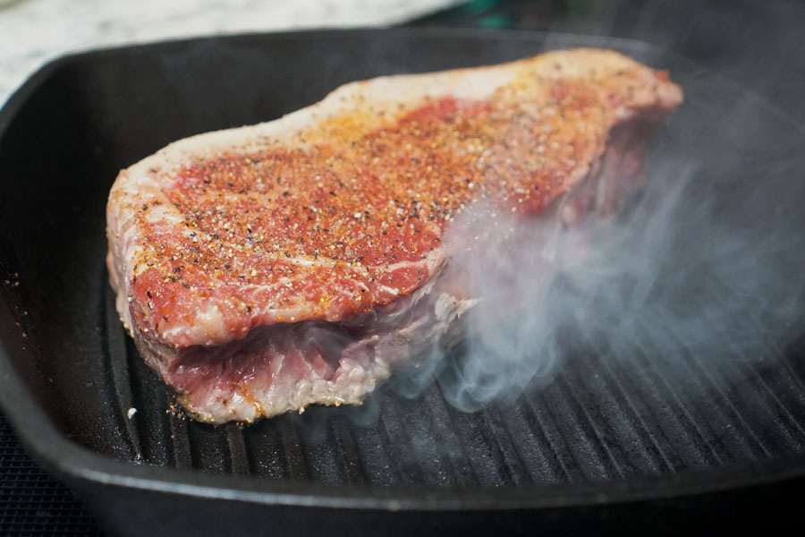 prime steak on black skillet