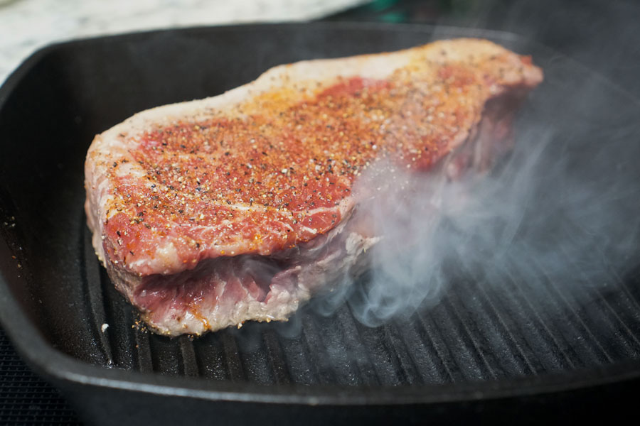 9 Tips on Cooking the Perfect NY Strip Prime Steak 1 prime steak on black skillet
