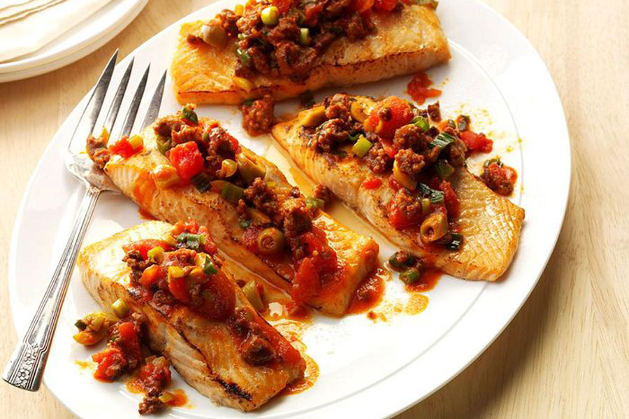 Order Chorizo Online for the Ultimate Seafood Combination! 1 grilled salmon on plate topped with our Mexican chorizo from Chorizo De San Manuel